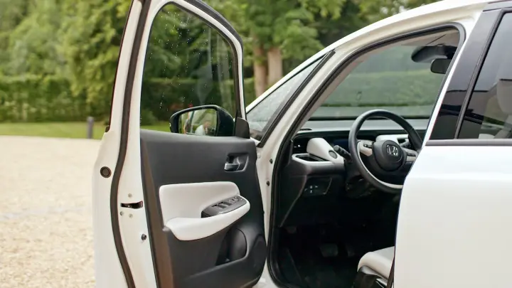 Detailný záber na model Honda Jazz Hybrid s otvorenými dverami na strane vodiča.