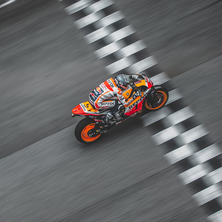 Jazdec Honda v pretekoch MotoGP prechádza cieľovou čiarou.