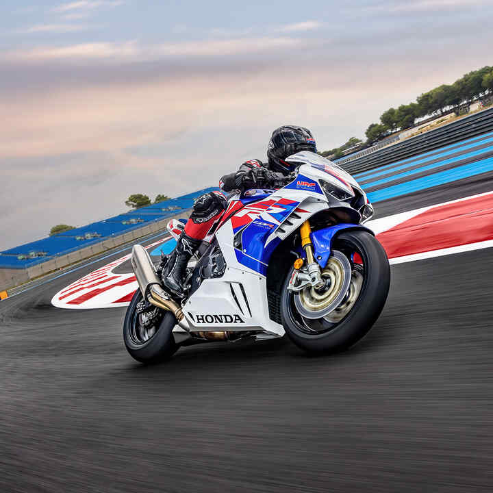 Predný trojštvrťový pohľad sprava na model Honda CBR1000RR-R-Fireblade s jazdcom na pretekárskej trati